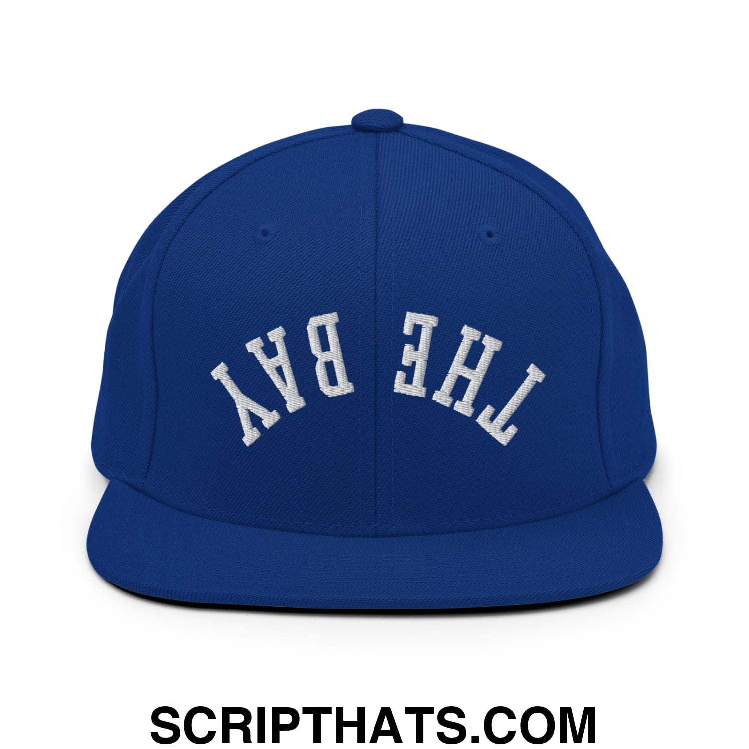 Royal blue snapback hat with white embroidered the bay lettering and flat bill brim in classic arched design