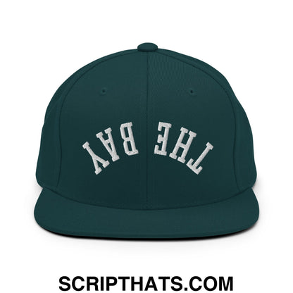 Dark green snapback hat with white embroidered the bay lettering and flat bill brim for casual wear