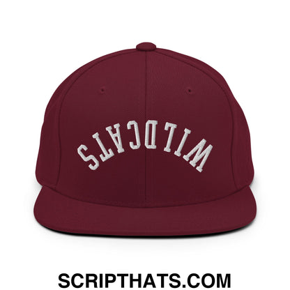 Maroon flat bill brim snapback hat with white embroidered wildcats lettering in an arched design