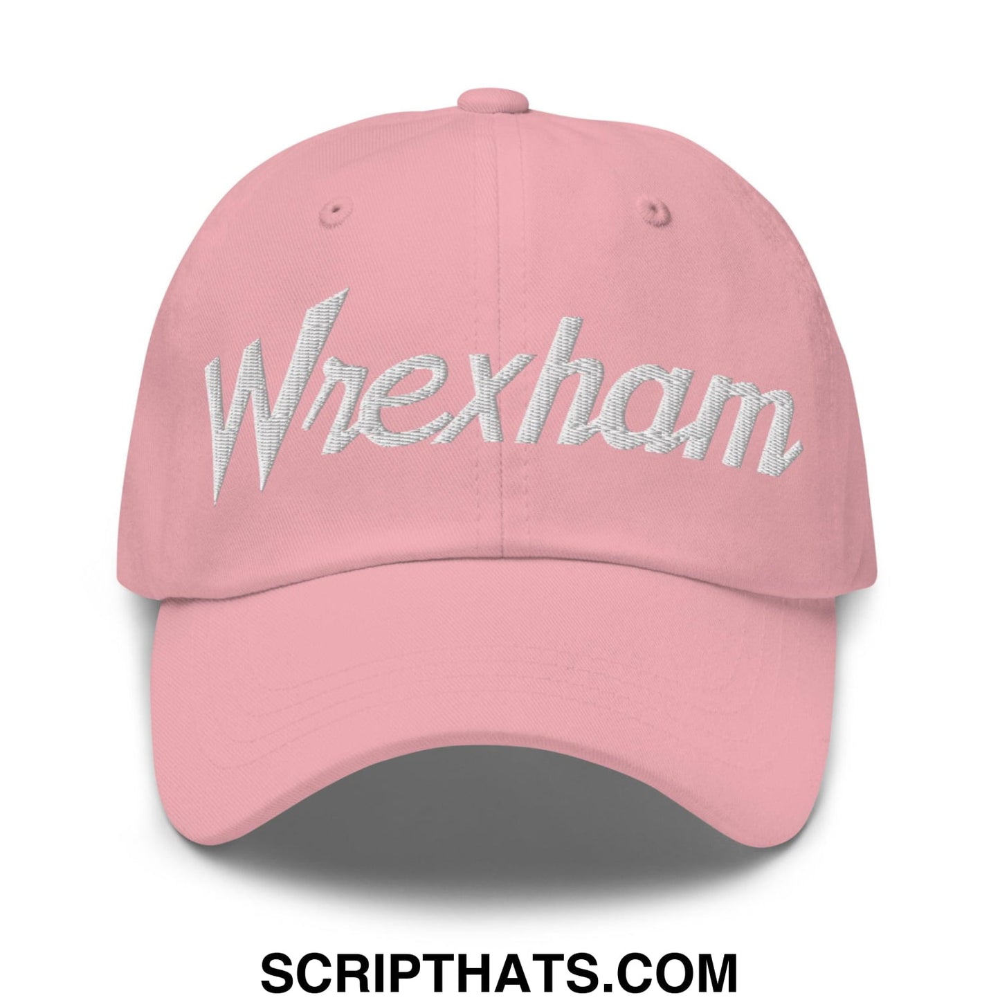 A soft pink wrexham vintage sports script dad hat with shimmering silver embroidered logo on the front