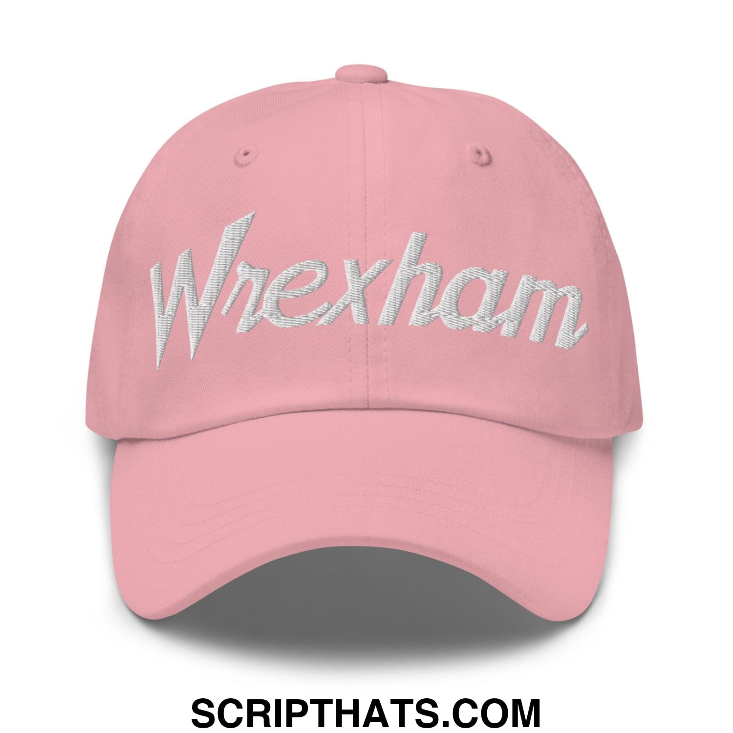 A soft pink wrexham vintage sports script dad hat with shimmering silver embroidered logo on the front