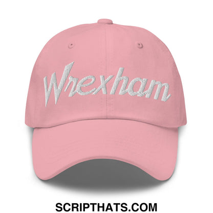 A soft pink wrexham vintage sports script dad hat with shimmering silver embroidered logo on the front