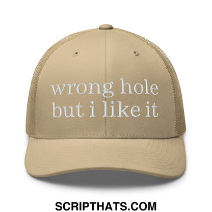 Beige mesh trucker hat with white embroidered text wrong hole but i like it across the front panel