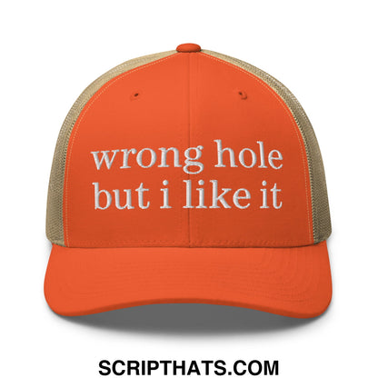 Orange and beige mesh trucker hat with white embroidered text wrong hole but i like it front view