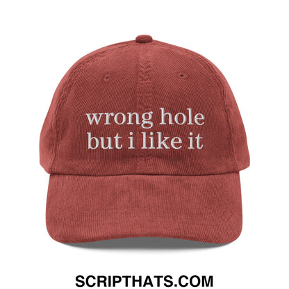 A rust-colored corduroy dad hat with white embroidered text wrong hole but i like it unstructured design