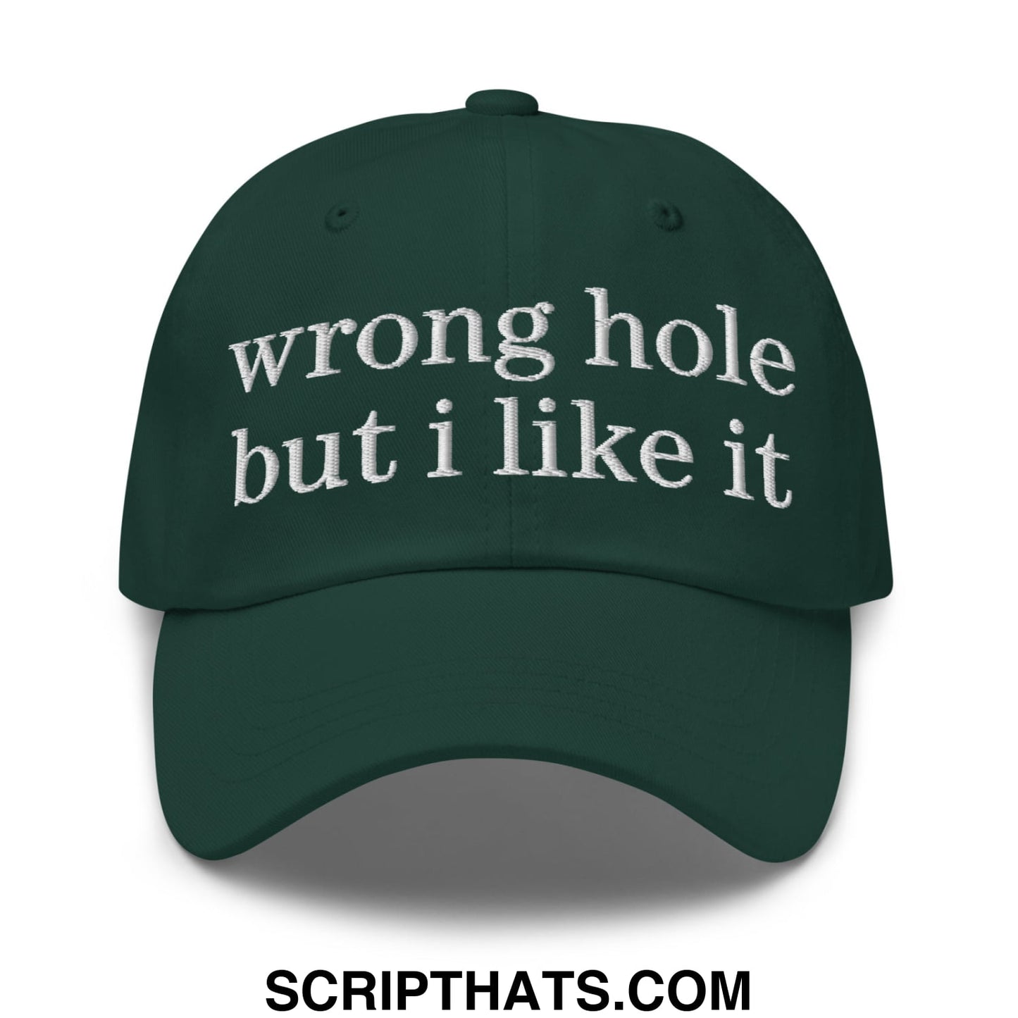 Dark green unstructured dad hat with white embroidered text reading wrong hole but i like it worn as a baseball cap