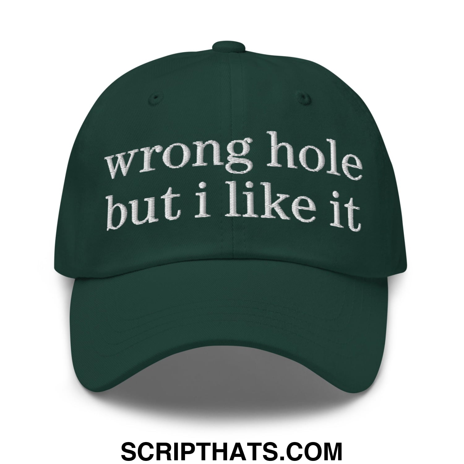 Dark green unstructured dad hat with white embroidered text reading wrong hole but i like it worn as a baseball cap