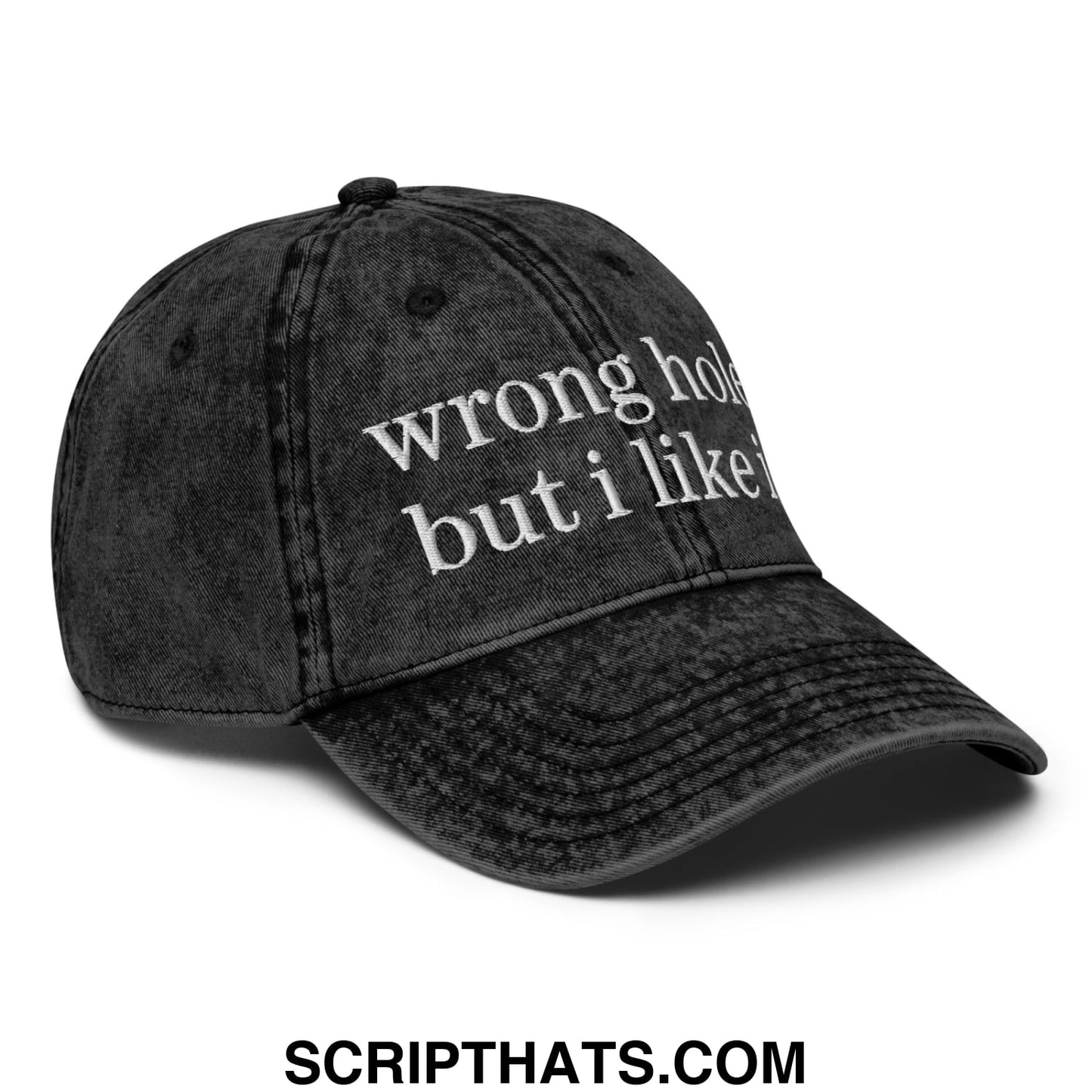 A black distressed denim dad hat with white embroidered text wrong hole but i like it in an unstructured design