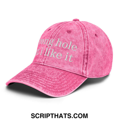 A faded pink unstructured denim dad hat with white embroidered text reading wrong hole it i like it
