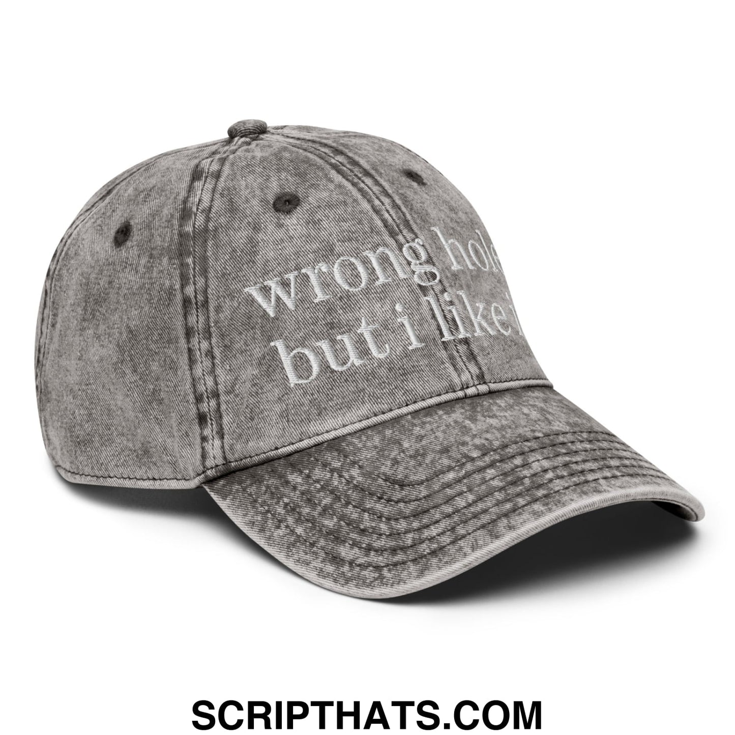 A faded gray denim unstructured dad hat embroidered with white text reading wrong hat but i like it