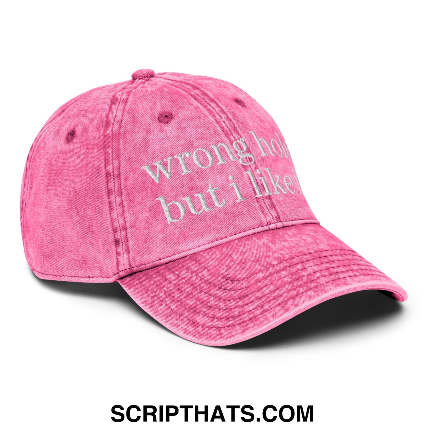 A faded pink unstructured denim dad hat with wrong hole but i like it embroidered in white thread on the front