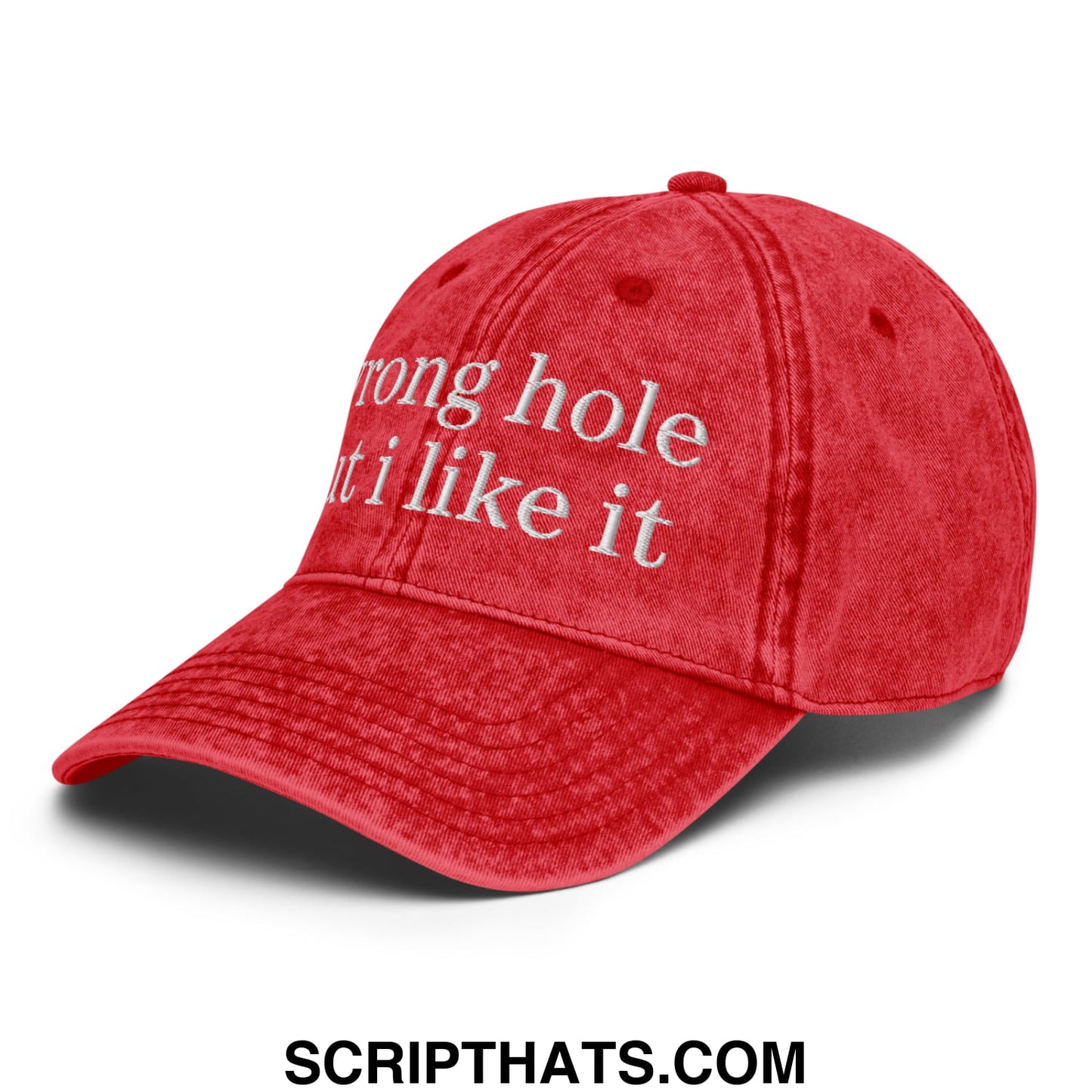 Red denim unstructured dad hat with white embroidered text reading wrong hole but i like it