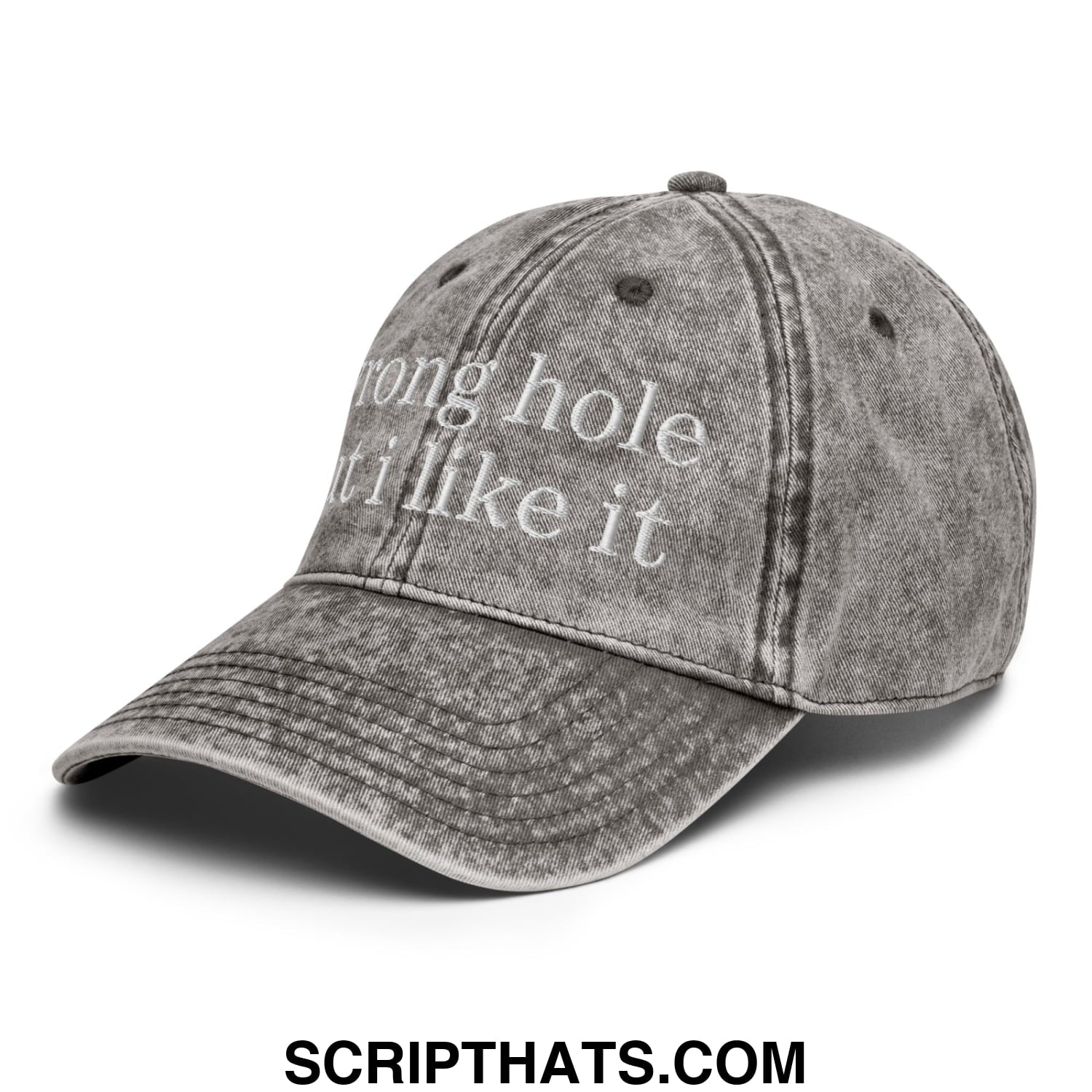 A faded gray denim dad hat with white embroidered wrong hole but i like it text on the front panel