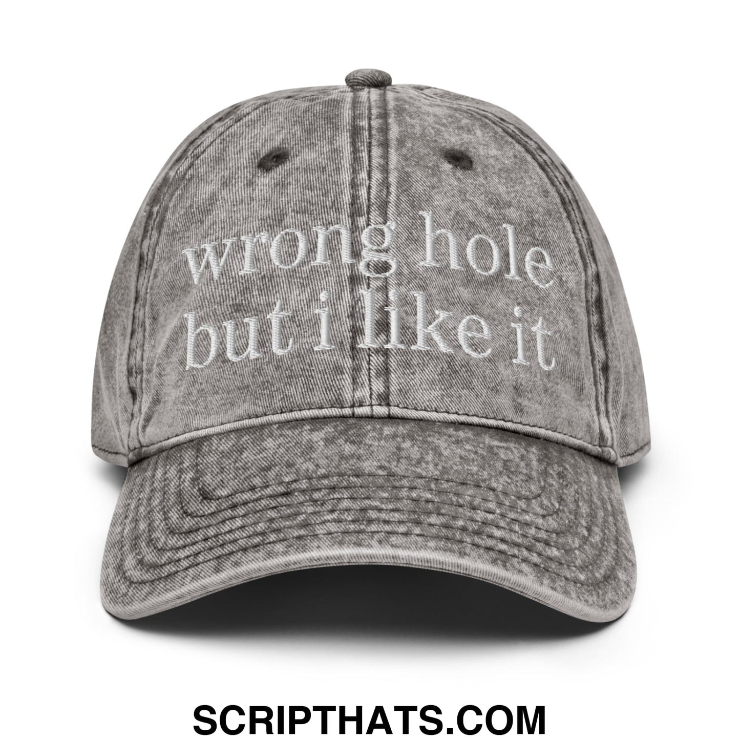 A faded gray denim baseball dad hat with white embroidered text wrong hole but i like it on front panel
