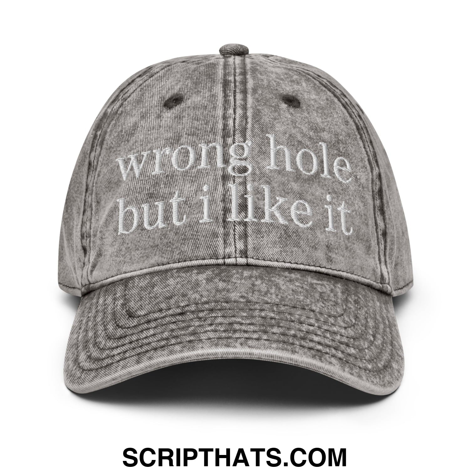 A faded gray denim baseball dad hat with white embroidered text wrong hole but i like it on front panel