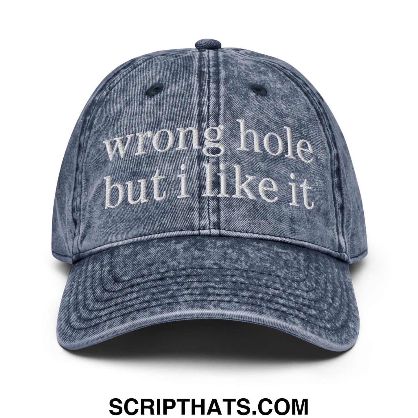 A faded blue denim dad hat with white embroidered text wrong hole but i like it unstructured baseball cap