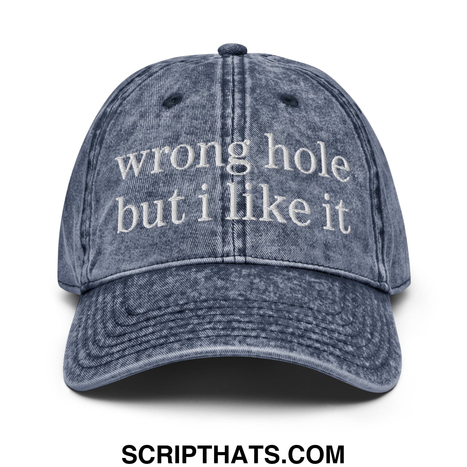 A faded blue denim dad hat with white embroidered text wrong hole but i like it unstructured baseball cap