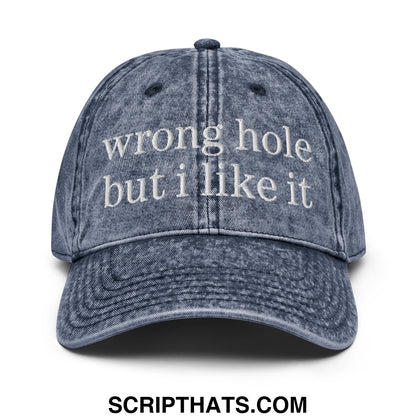 A faded blue denim dad hat with white embroidered text wrong hole but i like it unstructured baseball cap