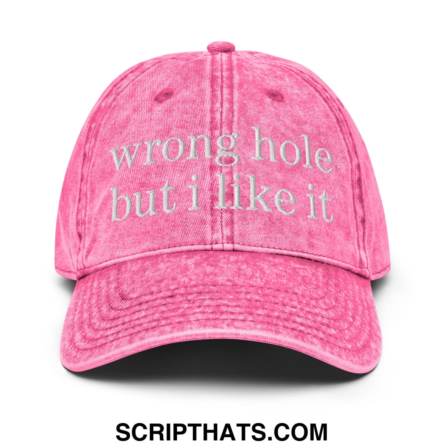 A faded pink unstructured denim dad hat with wrong hole but i like it embroidered in white thread on the front