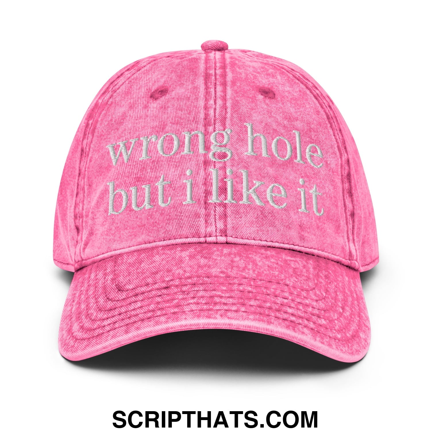 A faded pink unstructured denim dad hat with wrong hole but i like it embroidered in white thread on the front
