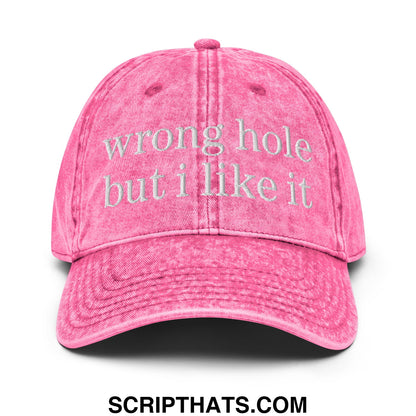 A faded pink unstructured denim dad hat with wrong hole but i like it embroidered in white thread on the front